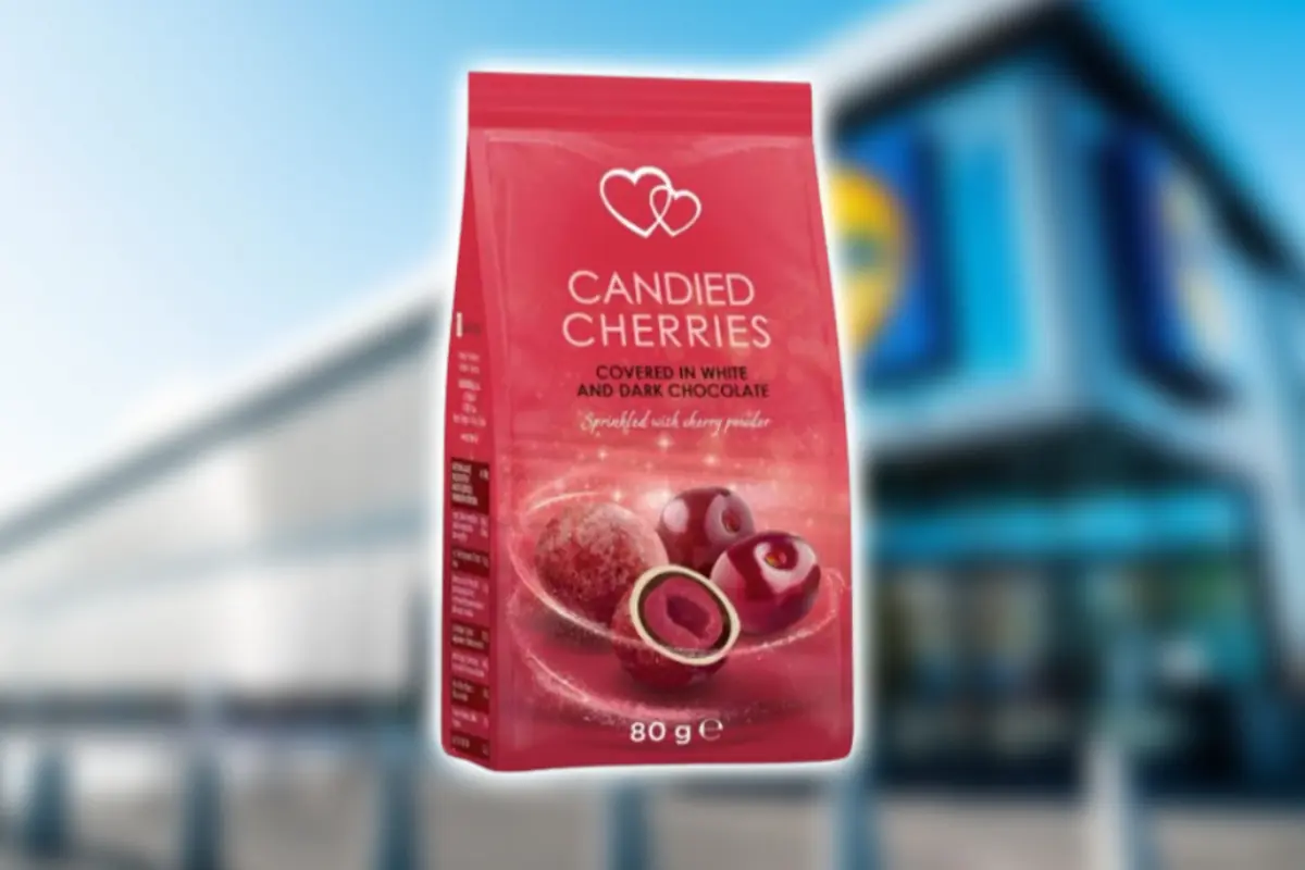 80 g red bag of candied cherries covered in white and dark chocolate in front of a blurred supermarket