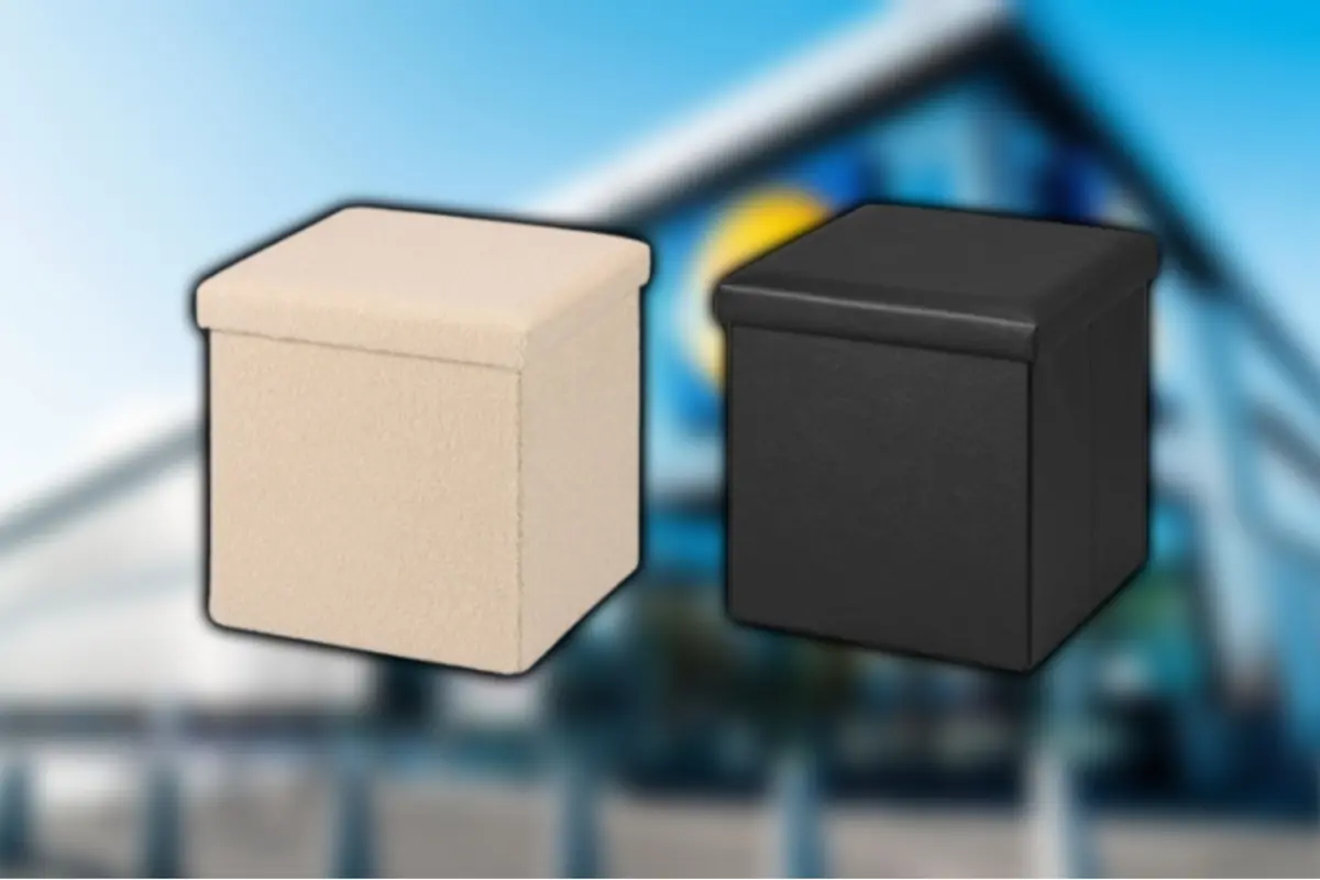 Two cube-shaped folding stools in beige and black on a blurred background of a commercial building