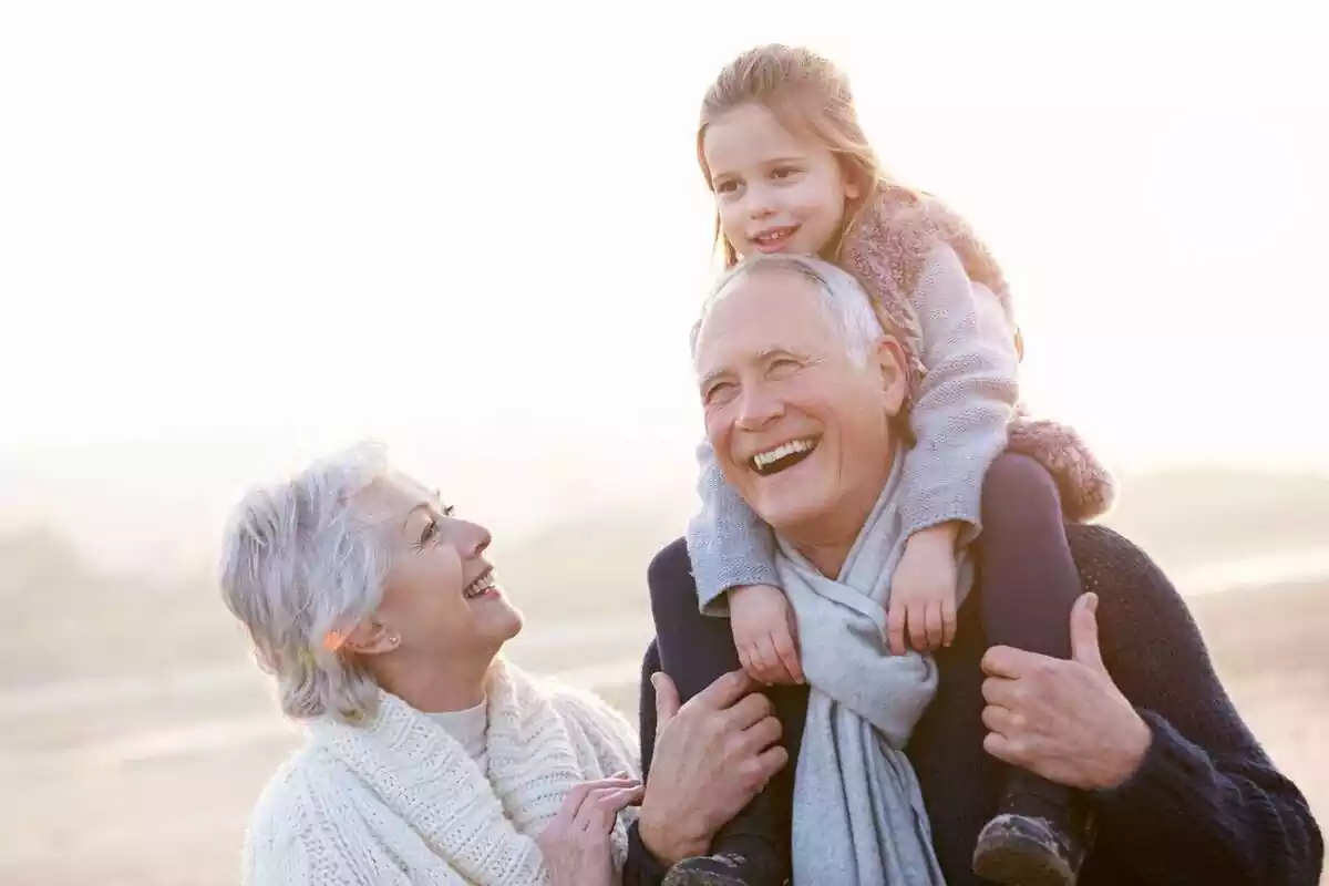 Grandparents with their granddaughter smiling