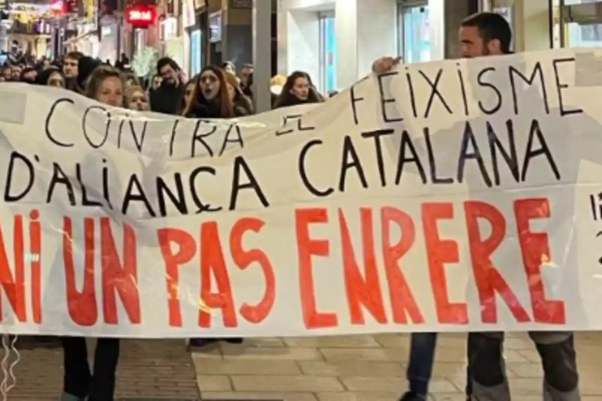 Un grupo de personas sostiene una pancarta en una manifestación en la calle.