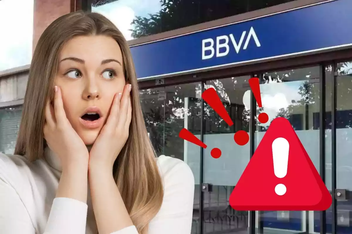 Dona sorpresa davant d'una sucursal del BBVA amb una icona d'advertència.