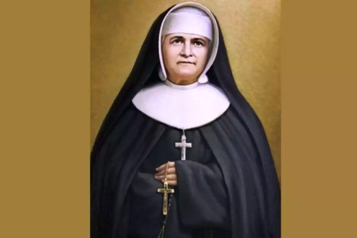 Una monja amb hàbit negre i blanc sostenint un rosari amb un crucifix. Una monja amb hàbit negre i blanc sostenint un rosari amb un crucifix.