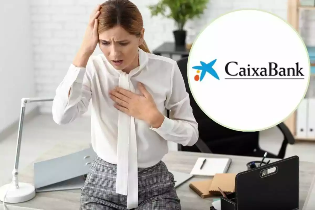 Una dona en una oficina amb expressió de preocupació, tocant-se el pit i el cap, amb el logotip de CaixaBank a la cantonada superior dreta.