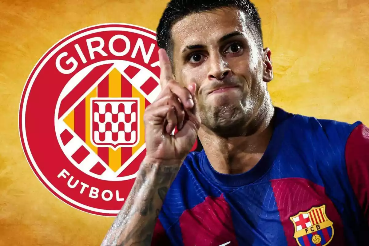 Joao Cancelo assenyalant amb el dit al davant amb un escut del Girona