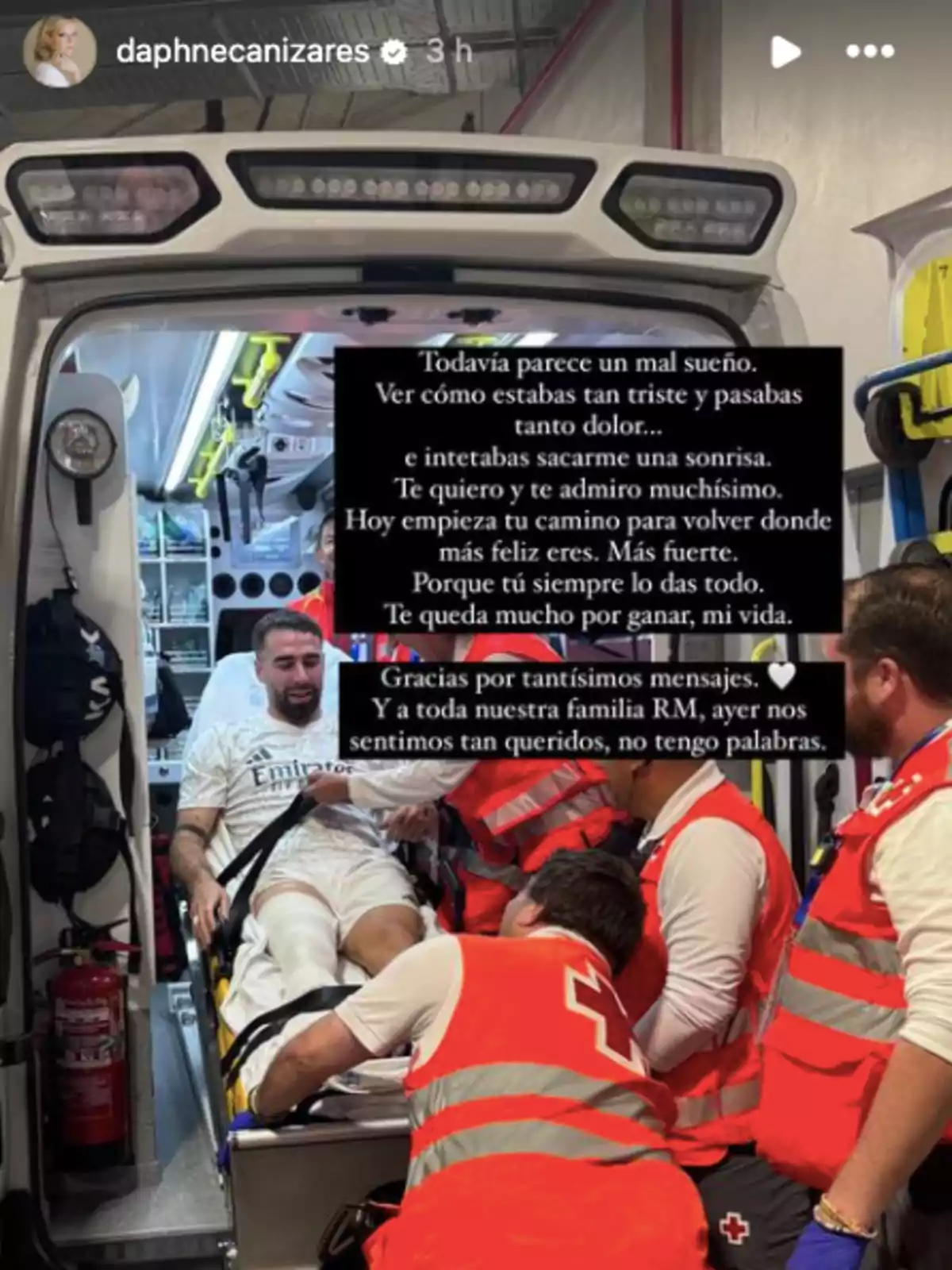Dani Carvajal is being treated by paramedics in an ambulance, while wearing a white sports shirt. There is a message superimposed on the image. Dani Carvajal is being treated by paramedics in an ambulance, while wearing a white sports shirt. There is a message superimposed on the image.