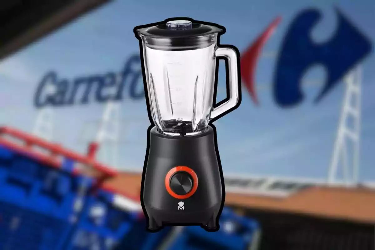 A black blender with red details is in the foreground with a blurred background showing a store logo. A black blender with red details is in the foreground with a blurred background showing a store logo.