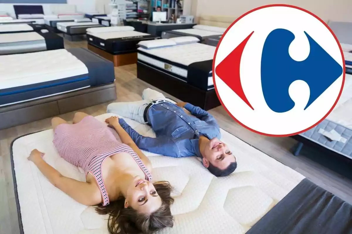 Two people lying on a mattress in a mattress store with a large logo overlaid.