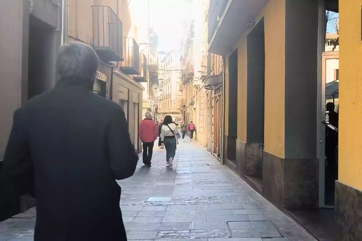 Image of a street in Ripoll with several citizens walking Image of a street in Ripoll with several citizens walking