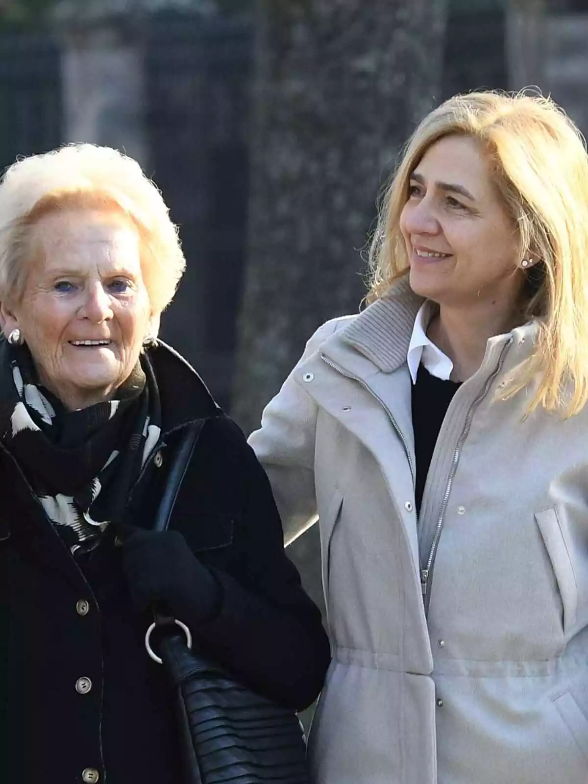 Claire Liebert and Infanta Cristina walk together, laughing