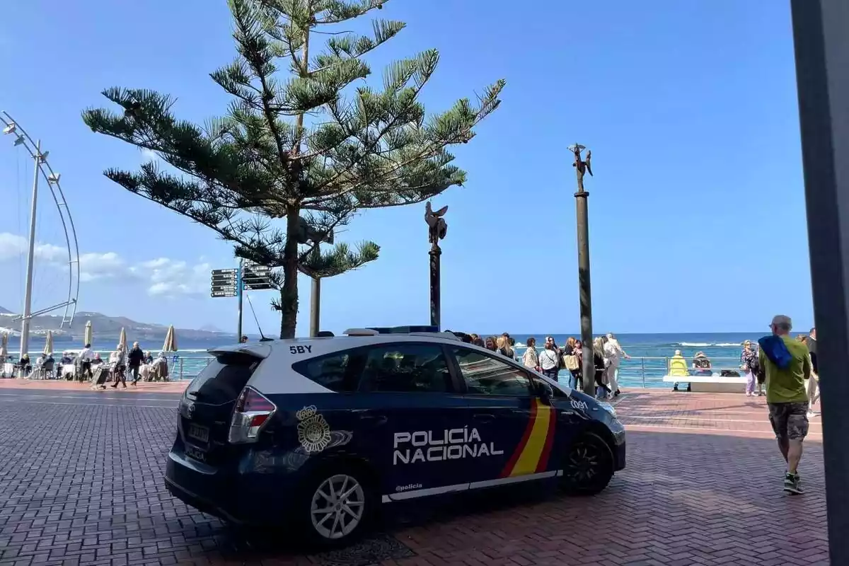 Un cotxe de policia nacional aparcat al costat d´un passeig marítim