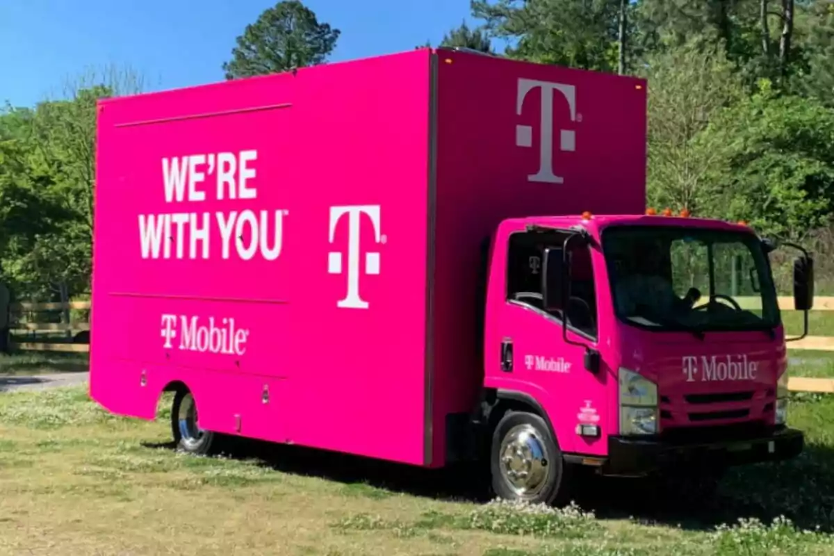 A bright pink truck with the T-Mobile logo and the text A bright pink truck with the T-Mobile logo and the text
