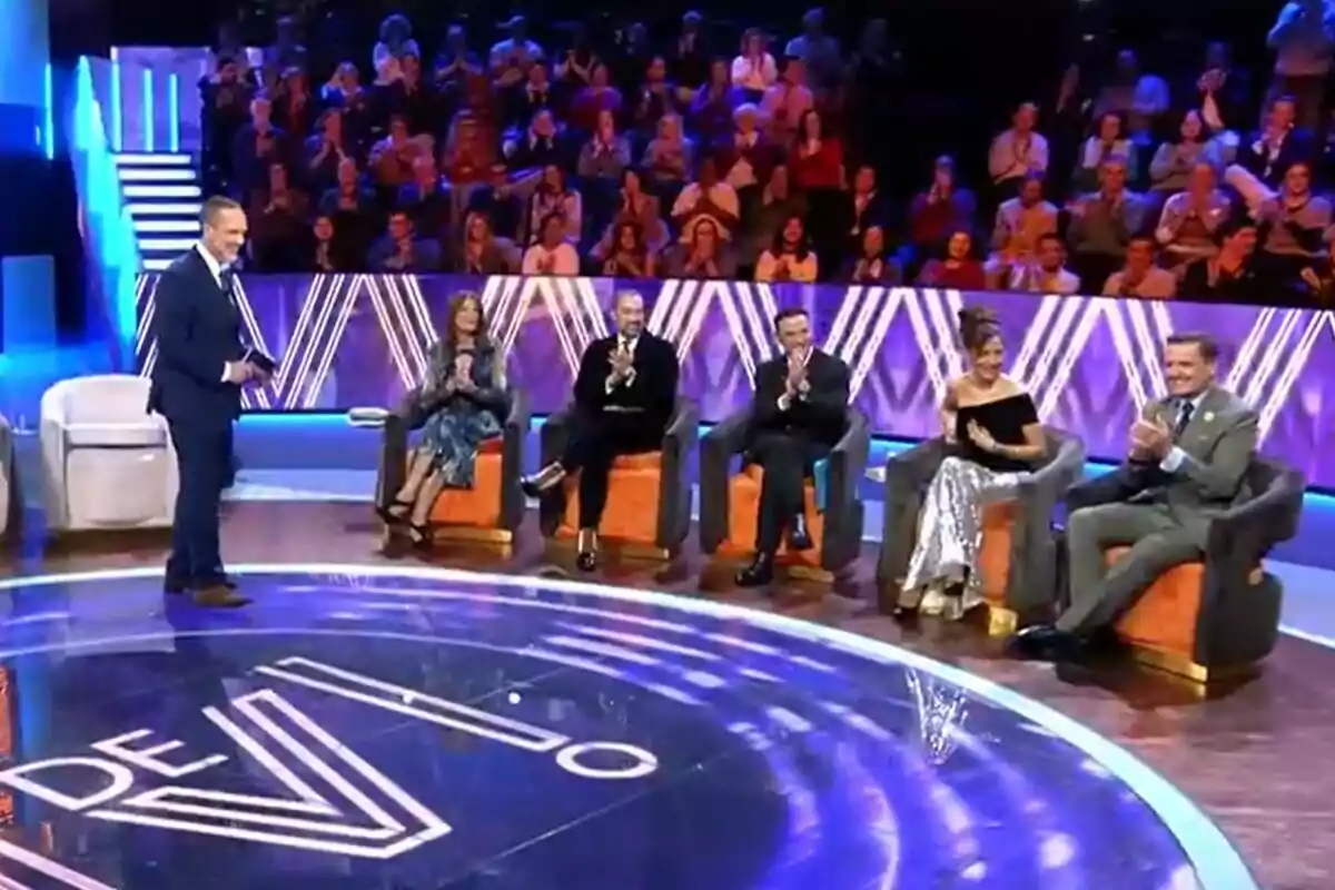 Un grup de persones està assegut a De Viernes, Santi Acosta dret davant d'Ángela Portero, José Antonio León, Antonio Rossi, Patricia Pérez i Antonio Montero, mentre el públic aplaudeix des de les grades. Un grup de persones està assegut a De Viernes, Santi Acosta dret davant d'Ángela Portero, José Antonio León, Antonio Rossi, Patricia Pérez i Antonio Montero, mentre el públic aplaudeix des de les grades.