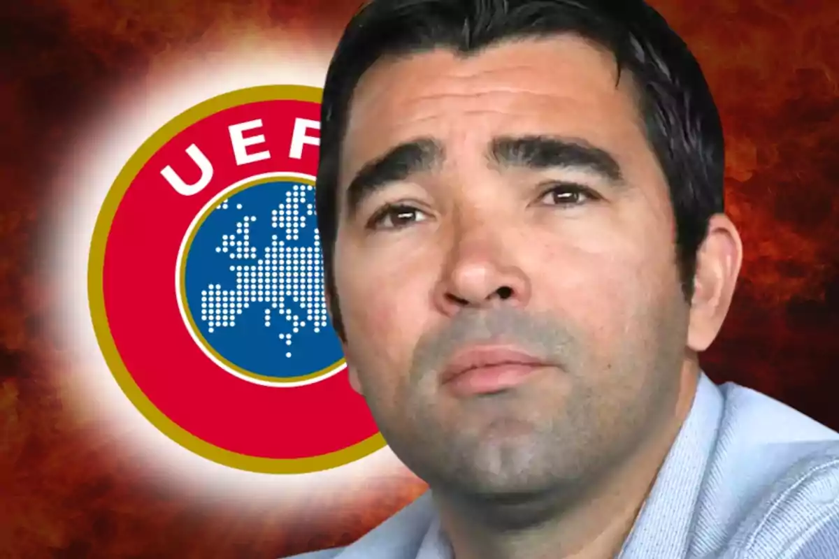 Home de cabells foscos amb expressió seriosa davant d’un logotip de la UEFA sobre un fons vermell.