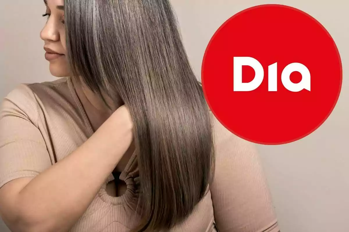 Una mujer con cabello lacio y canoso se toca el pelo mientras mira hacia un lado, junto a un logotipo rojo con la palabra "Dia".