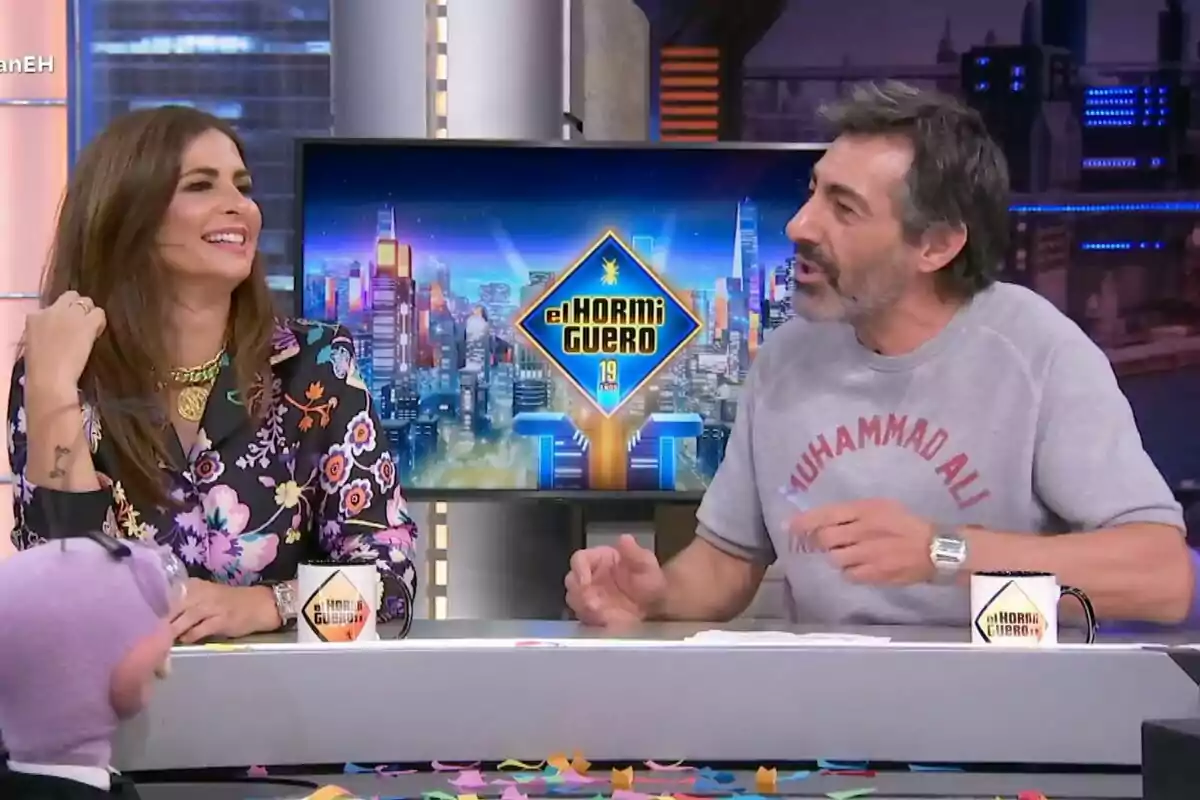 Nuria Roca i Juan del Val conversant i somrient a 'El Hormiguero' amb un fons acolorit i una taula plena de confeti. Nuria Roca i Juan del Val conversant i somrient a 'El Hormiguero' amb un fons acolorit i una taula plena de confeti.