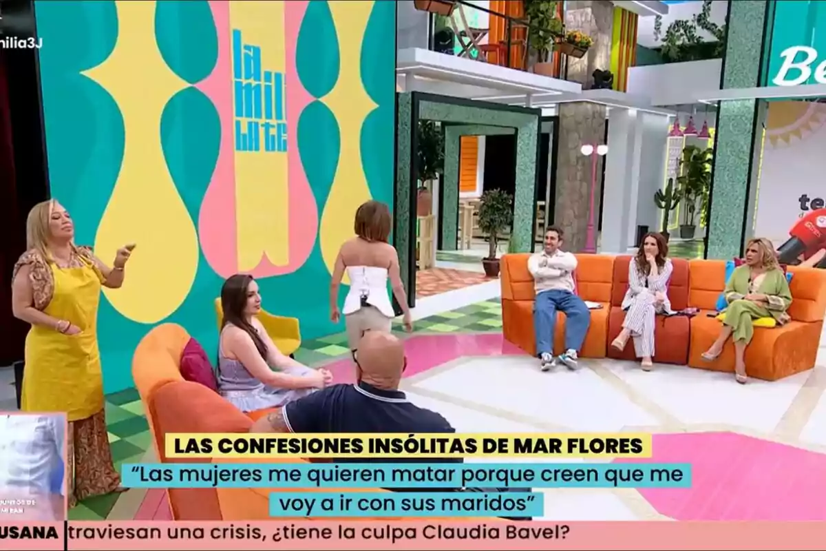 Set de La Família de la Tele acolorit amb Kiko Matamoros, Inés Hernand, María Patiño, Aitor Albizua, Laura Fa i Lydia Lozano assegudes en butaques taronges i Belén Esteban dreta amb un davantal groc; al fons es veu un rètol que diu Set de La Família de la Tele acolorit amb Kiko Matamoros, Inés Hernand, María Patiño, Aitor Albizua, Laura Fa i Lydia Lozano assegudes en butaques taronges i Belén Esteban dreta amb un davantal groc; al fons es veu un rètol que diu