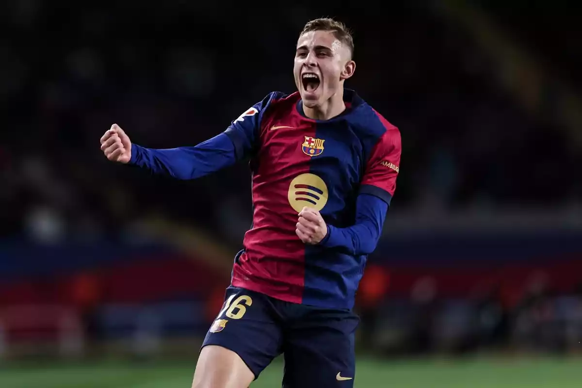 Football player celebrating a goal in FC Barcelona uniform.