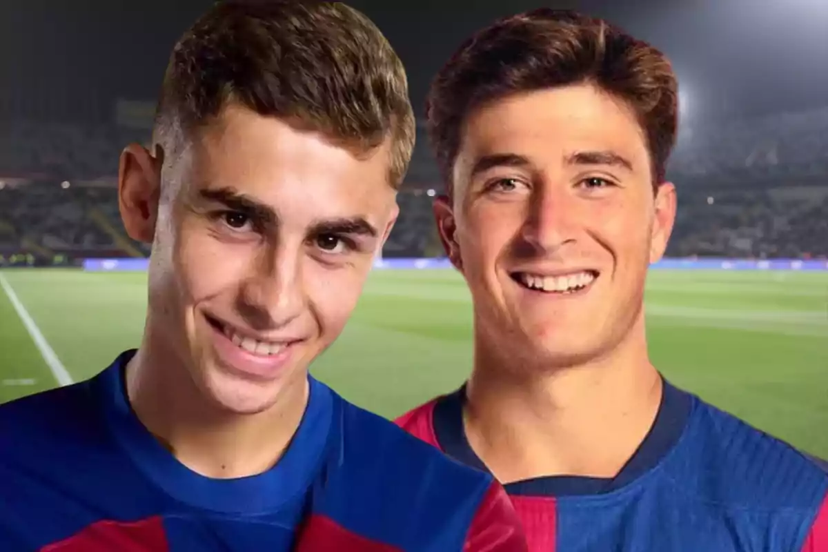 Two young people in soccer jerseys smile in a lit-up stadium.