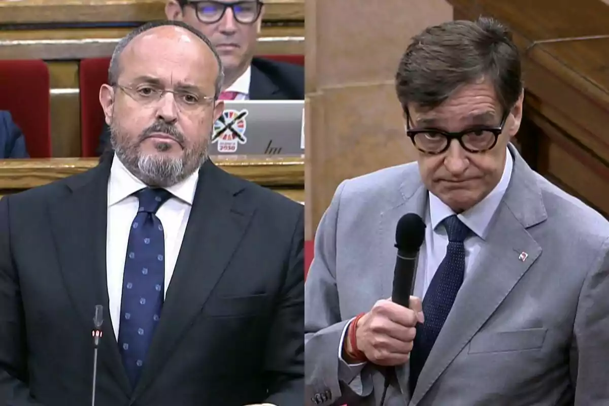 Dos homes amb vestit i corbata participen en un debat en un entorn parlamentari, un d’ells sosté un micròfon.