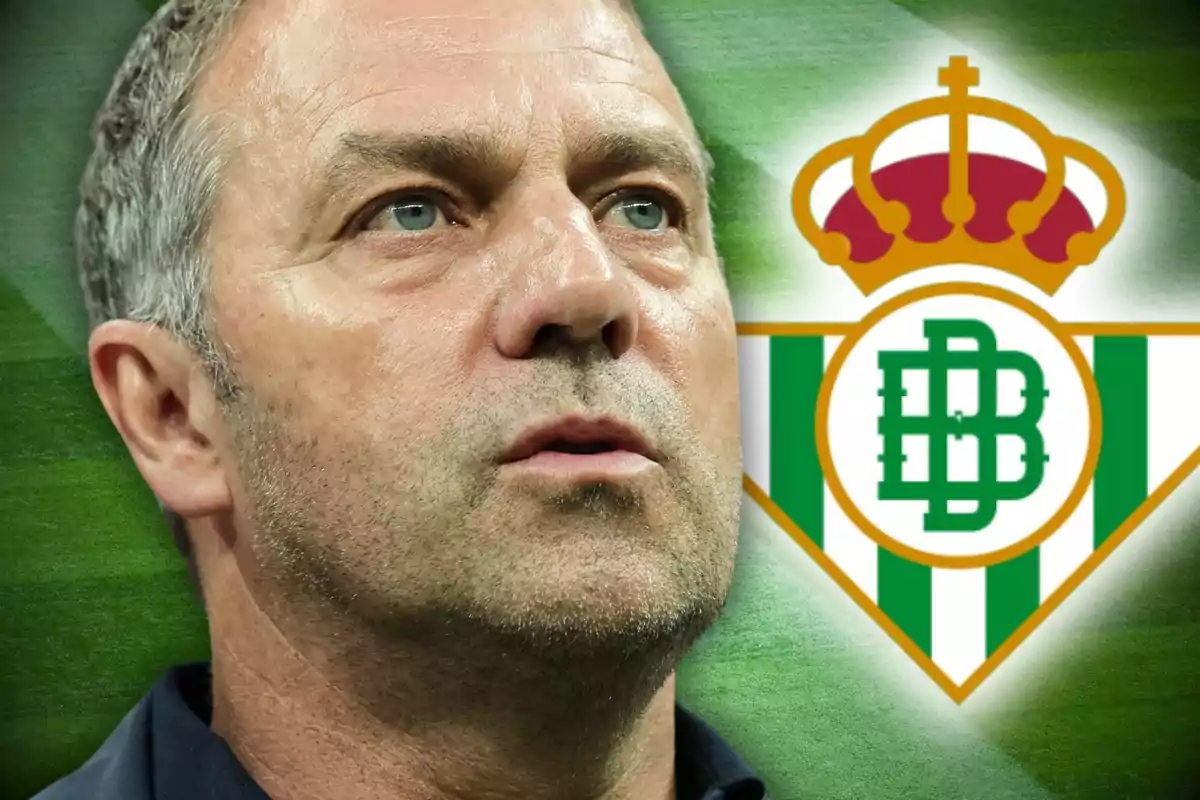 Un hombre con expresión seria frente al escudo del Real Betis.