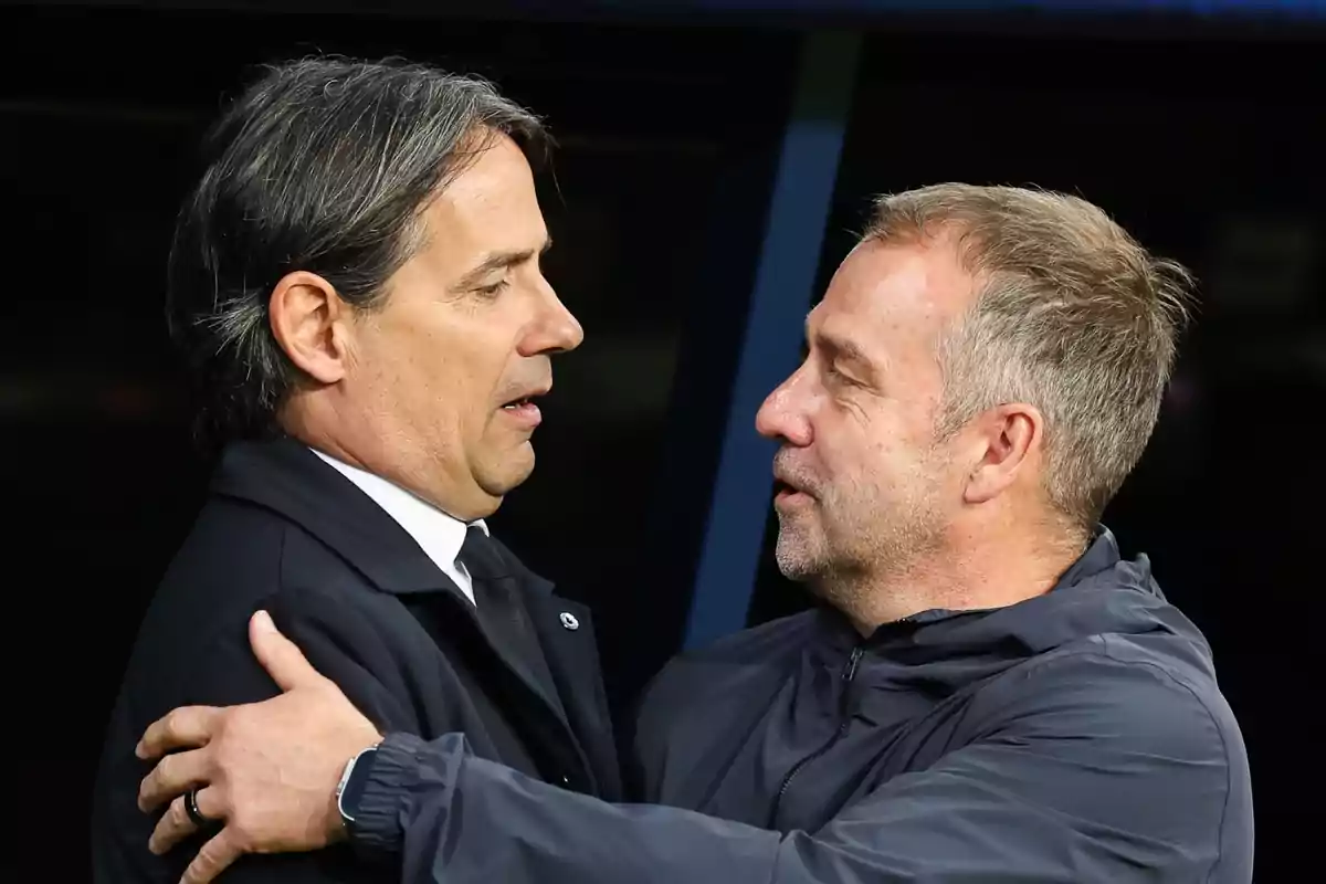 Two men greet each other with a hug in a formal setting.
