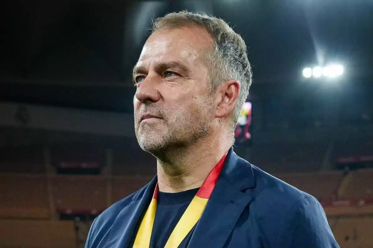 A man standing in a stadium with bright lights in the background. A man standing in a stadium with bright lights in the background.