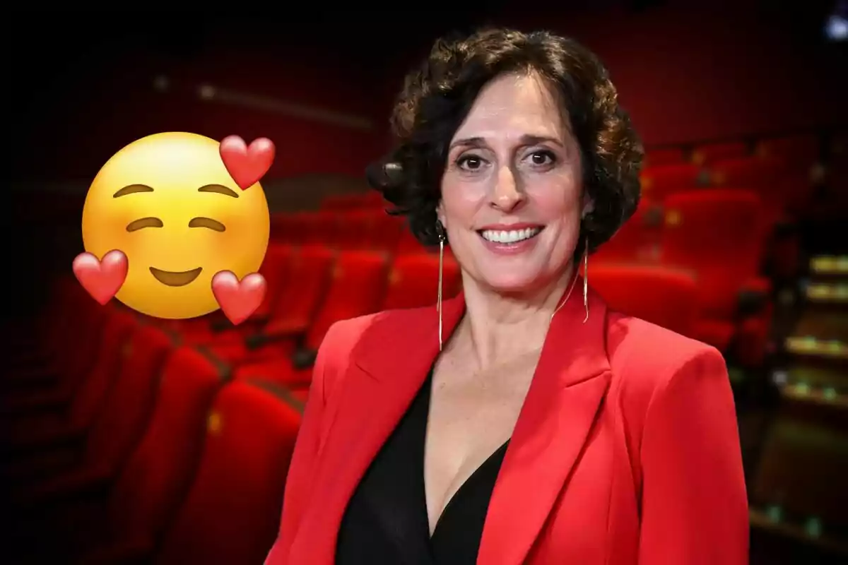 A person smiling with a smiling face emoji and hearts on a background of red seats.