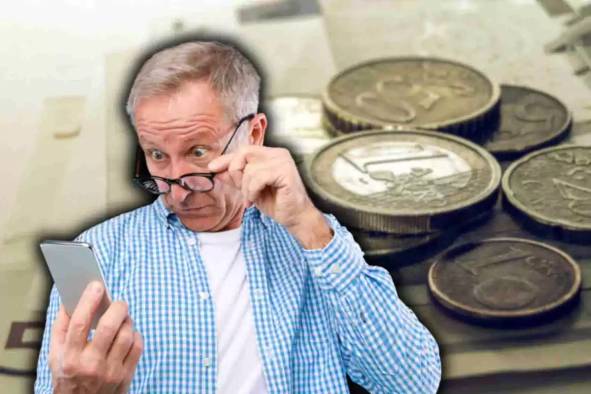 Old man in plaid shirt looking surprised at mobile phone with euro coins in background.