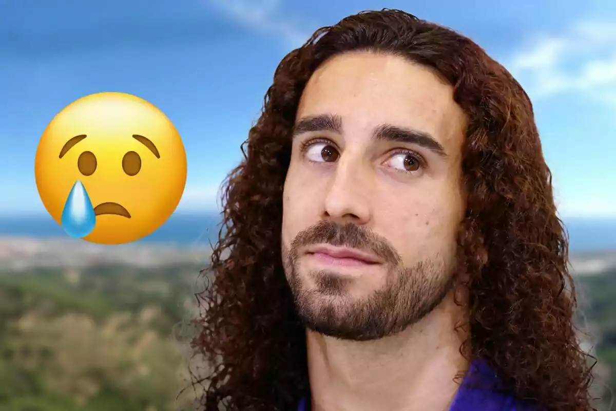 Un hombre con cabello rizado y barba mira hacia arriba con una expresión pensativa mientras un emoji de cara triste con una lágrima aparece a su lado sobre un fondo de paisaje.