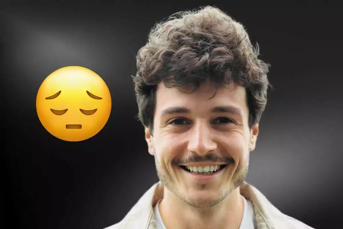 A smiling man with a sad face emoji next to him on a dark background.