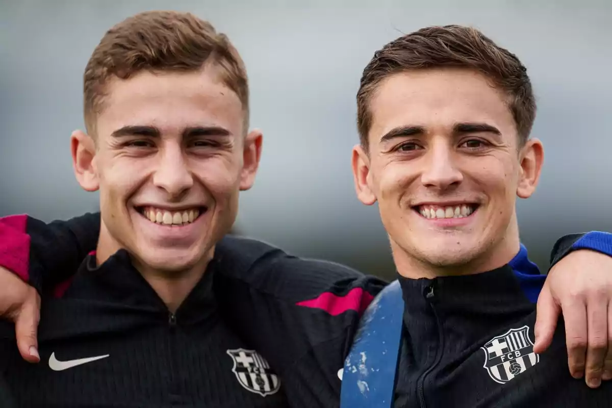 Two smiling young people wearing FC Barcelona sports jackets.