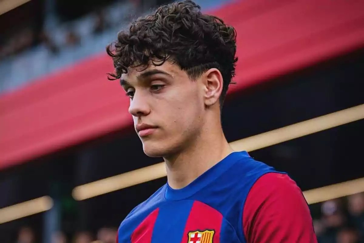 Young player wearing a blue and red FC Barcelona jersey in a stadium