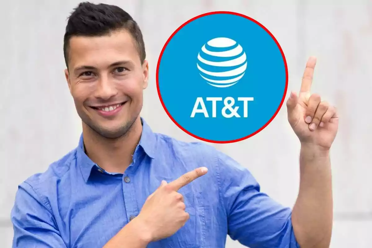 Un hombre sonriente con camisa azul señala el logotipo de AT&T dentro de un círculo rojo. Un hombre sonriente con camisa azul señala el logotipo de AT&T dentro de un círculo rojo.