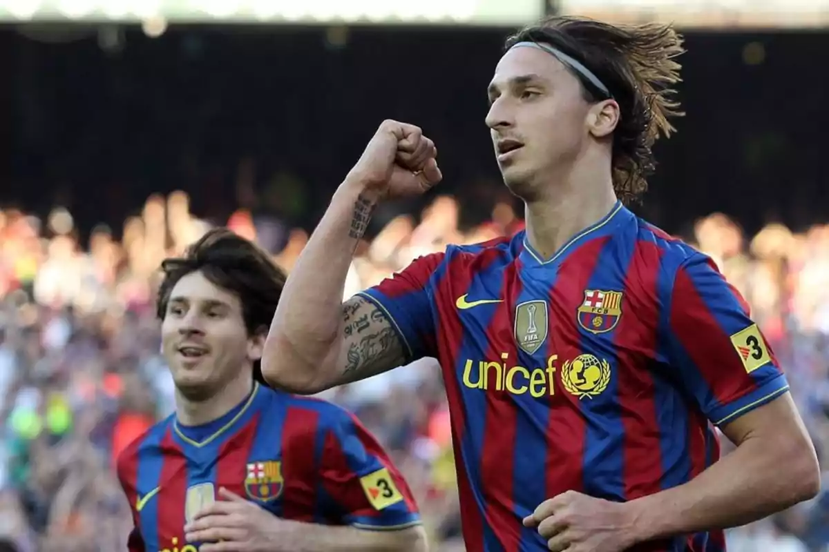 Two FC Barcelona soccer players celebrating a goal on the field. Two FC Barcelona soccer players celebrating a goal on the field.
