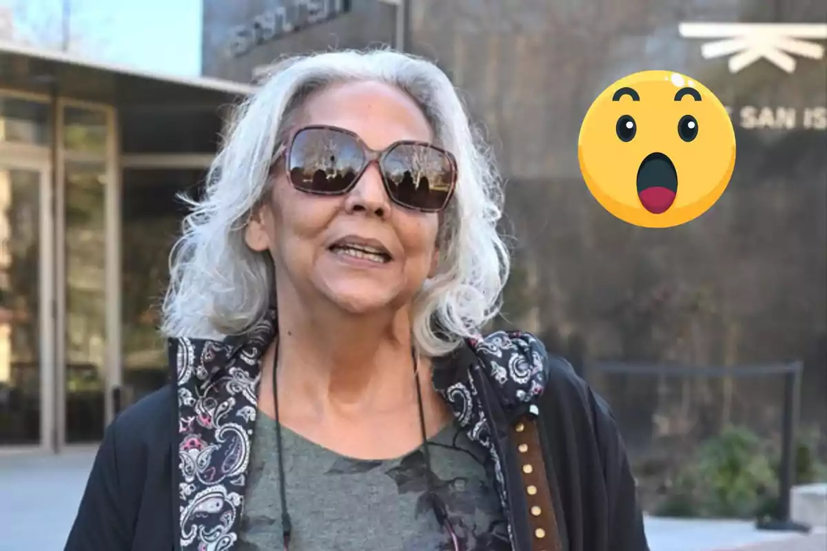 A woman with gray hair and sunglasses is outdoors with a surprised emoji next to her.