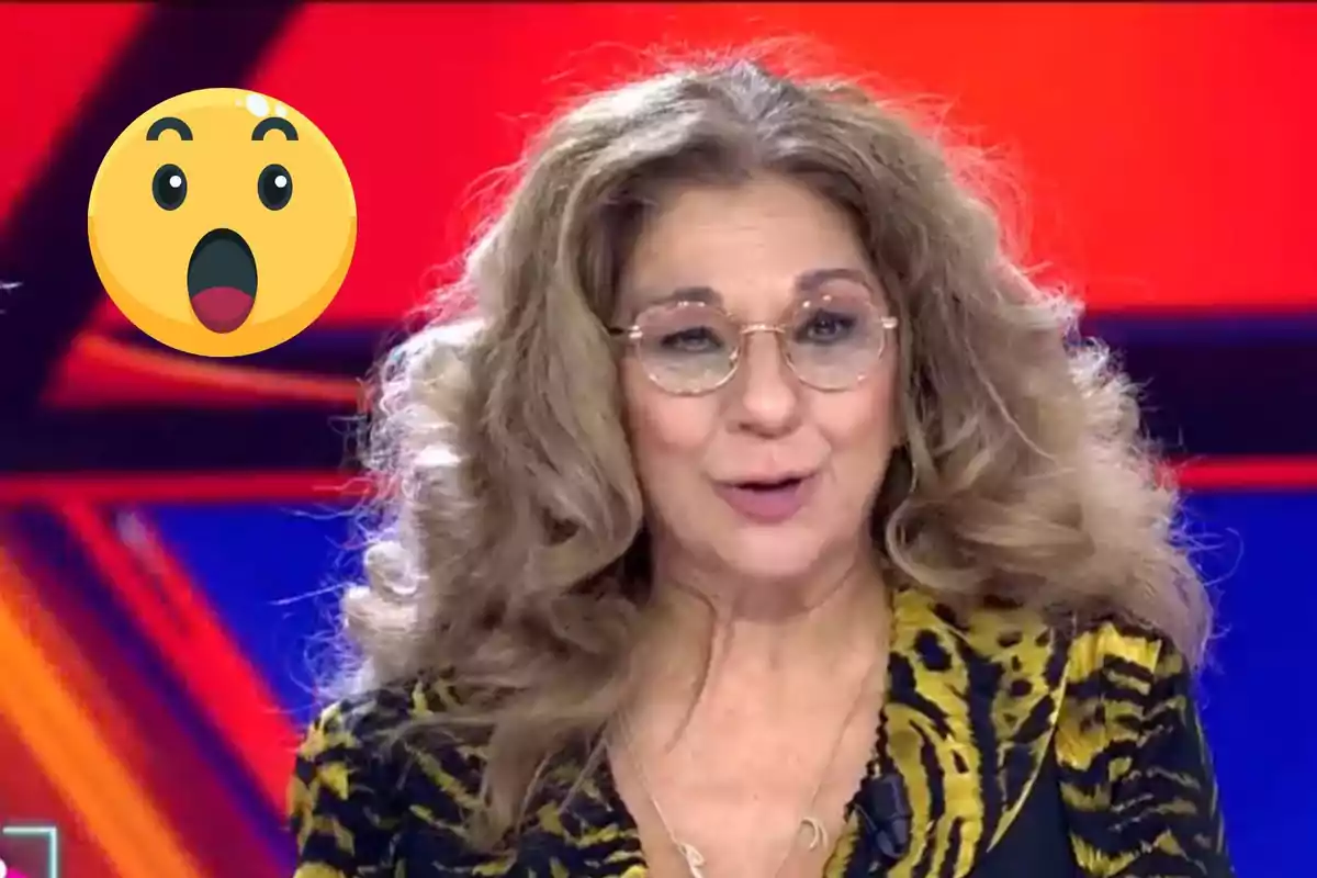 Lolita Flores con gafas y cabello rizado está hablando en un entorno colorido, con un emoji sorprendido al lado.