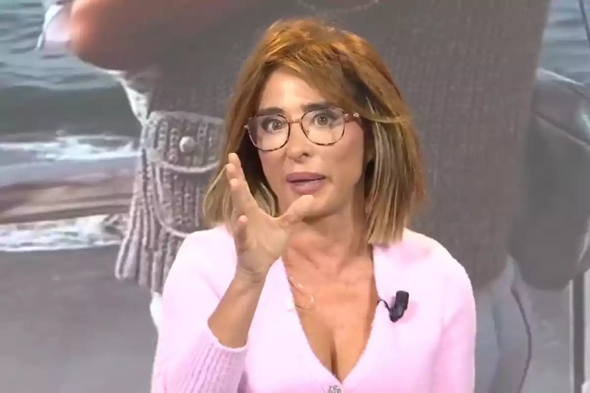 María Patiño con gafas y cabello castaño claro está hablando y gesticulando con la mano, lleva un micrófono en la ropa.