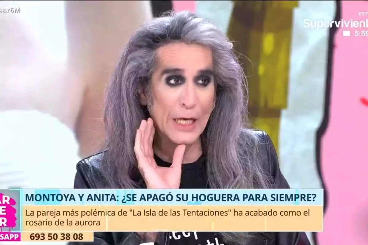 A person with long gray hair and dark eye makeup is speaking on a television show, with on-screen text mentioning a controversial couple from a reality show. A person with long gray hair and dark eye makeup is speaking on a television show, with on-screen text mentioning a controversial couple from a reality show.