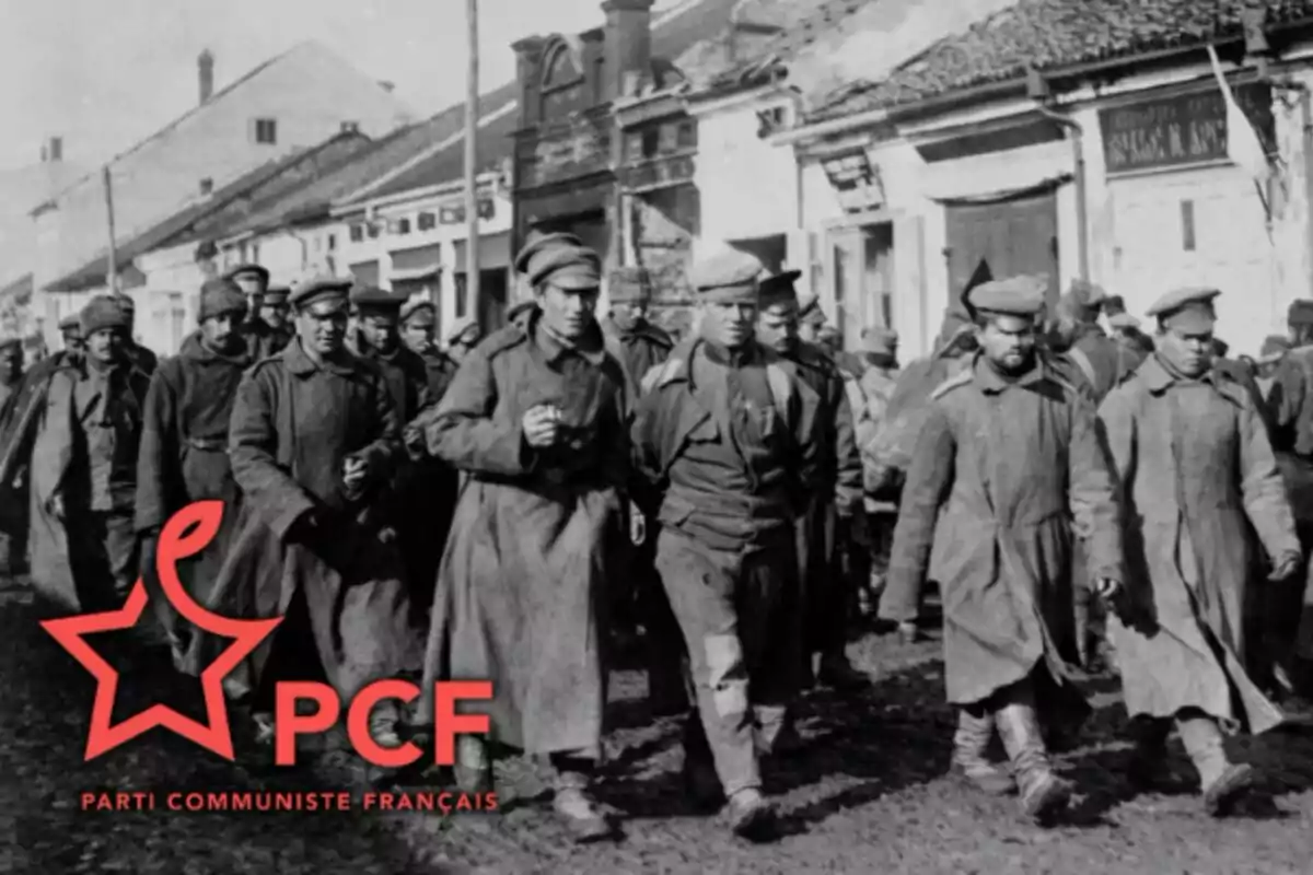 Soldats desfilant per un carrer amb cases al fons i el logotip del Partit Comunista Francès a la cantonada inferior esquerra. Soldats desfilant per un carrer amb cases al fons i el logotip del Partit Comunista Francès a la cantonada inferior esquerra.