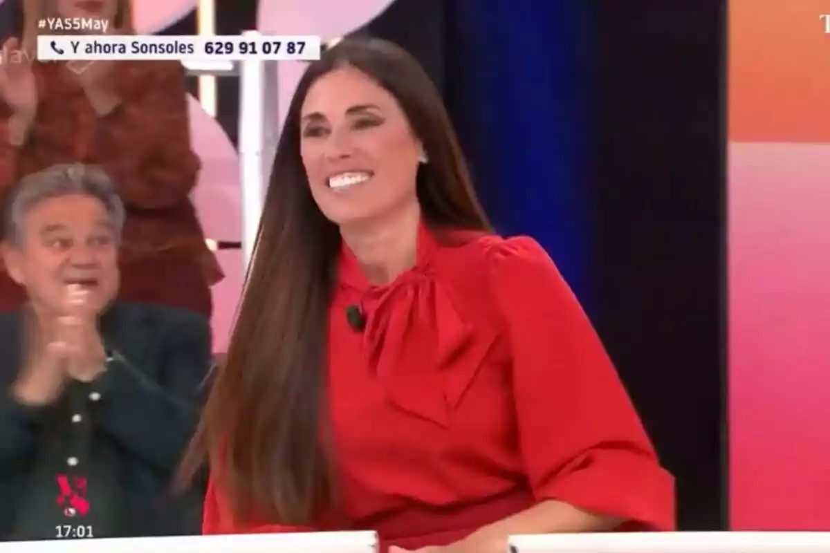 Isabel Rábago somrient amb un vestit vermell està asseguda a 'Y ahora Sonsoles', mentre una persona aplaudeix al fons. Isabel Rábago somrient amb un vestit vermell està asseguda a 'Y ahora Sonsoles', mentre una persona aplaudeix al fons.