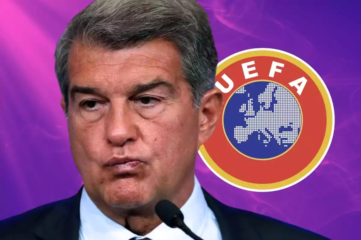 Un home amb expressió seriosa davant d'un logotip de la UEFA sobre un fons porpra.