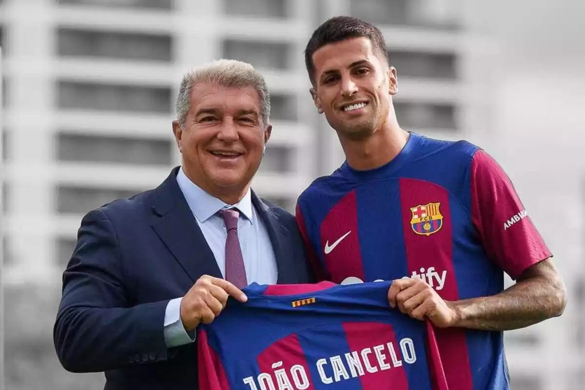 Joan Laporta posa amb Joao Cancelo subjectant una samarreta del FC Barcelona