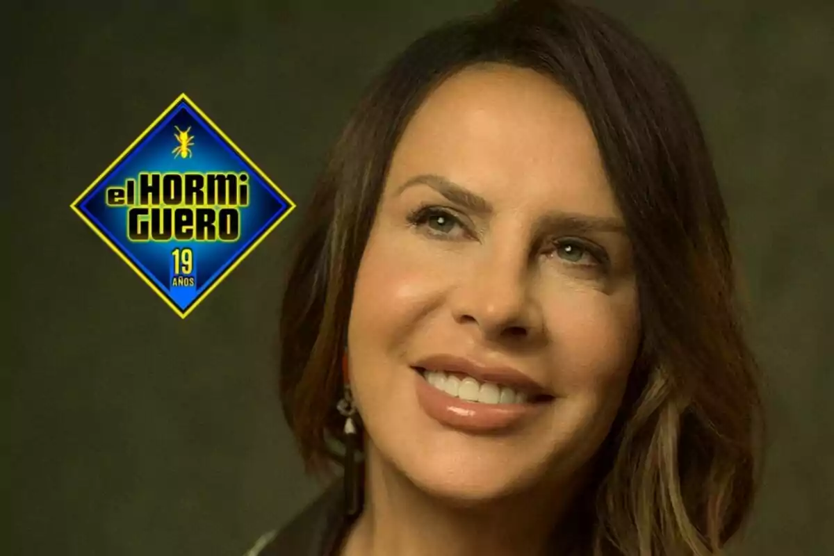 Karla Sofía Gascón somrient amb el logotip del programa "El Hormiguero" que celebra 19 anys.