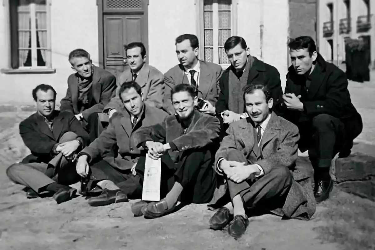 Un grup d'homes vestits amb vestits formals està assegut a l'aire lliure davant d'un edifici a la sèrie documental La conquesta de la democràcia. Un grup d'homes vestits amb vestits formals està assegut a l'aire lliure davant d'un edifici a la sèrie documental La conquesta de la democràcia.