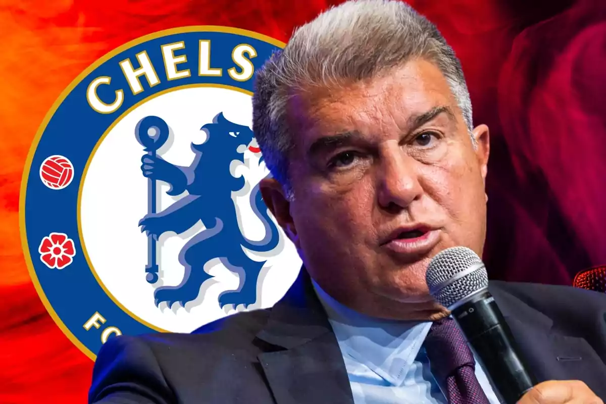 A man speaking into a microphone with the Chelsea FC logo in the background.