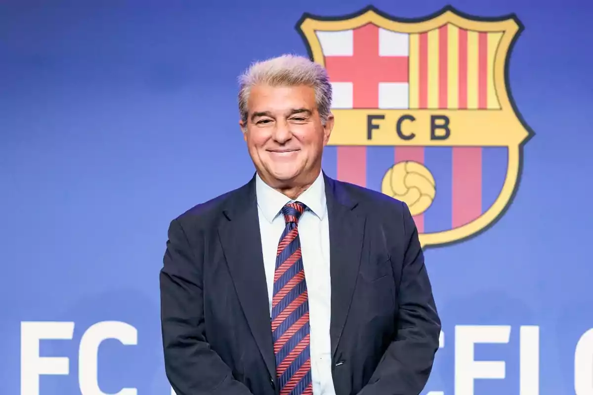 Home de vestit i corbata davant d'un logotip del FC Barcelona.