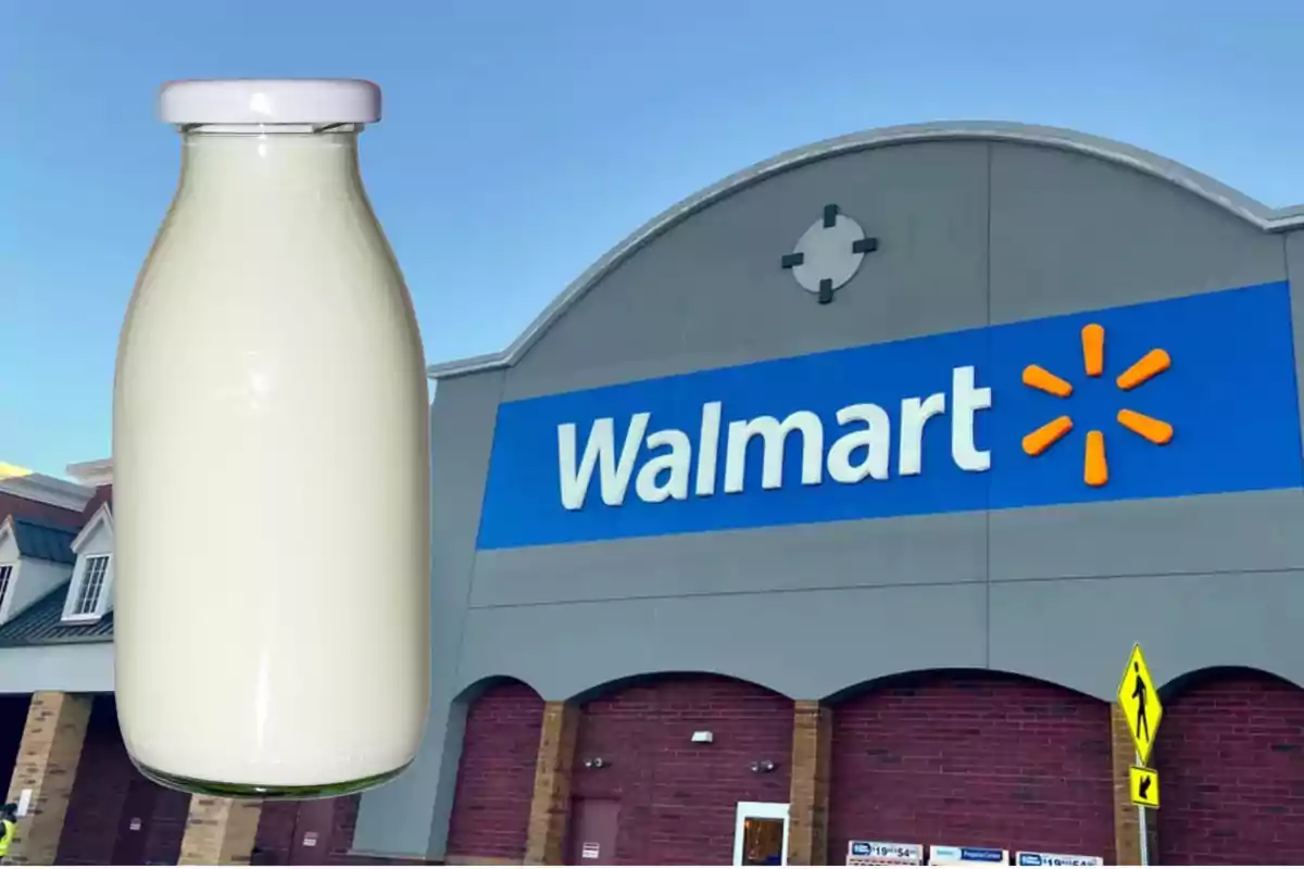 A bottle of milk in front of the facade of a Walmart store.