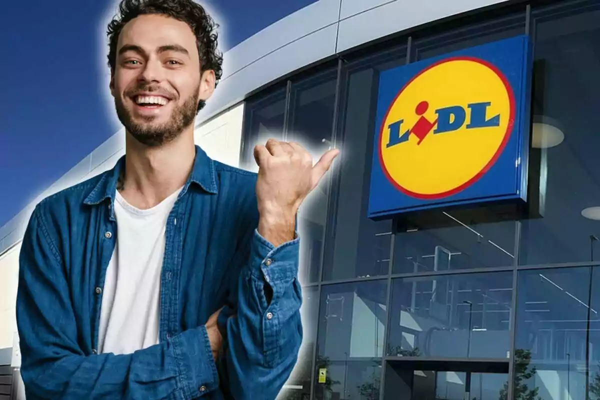 Un hombre sonriente con camisa de mezclilla señala hacia el logotipo de Lidl en la fachada de una tienda.