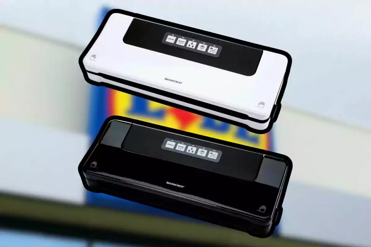Two SilverCrest vacuum sealers in white and black on a blurred background. Two SilverCrest vacuum sealers in white and black on a blurred background.