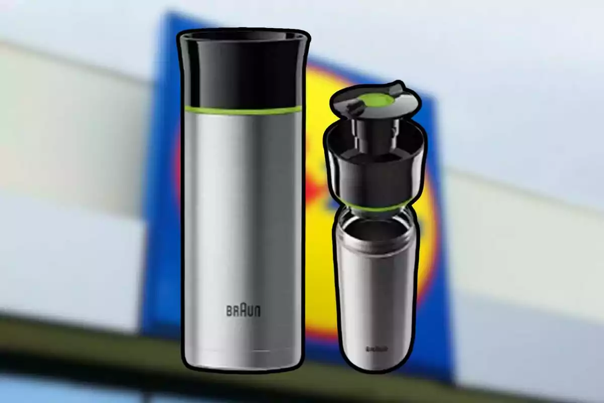 Stainless steel thermal mug with black lid and green details, Braun brand, on a blurred background.